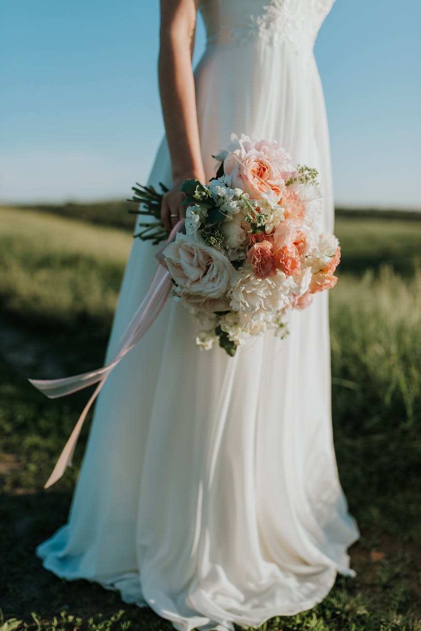 hand holding wedding bouquet of flowers