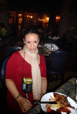 Maya smiling with her plate of roasted duck and sweet potatoes!