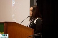 Maya at the podium talking about her dating experiences