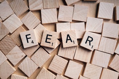fear scrabble letters scrabble game pieces that artfully spell out fear against blank tiles in background