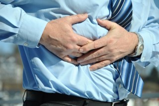 hands clutching stomach as if in pain