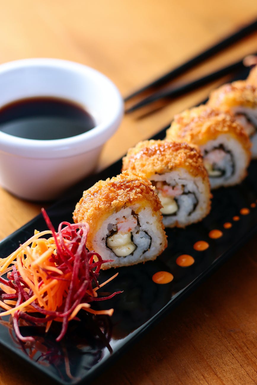 sushi pieces with coconut aminos in a small dish